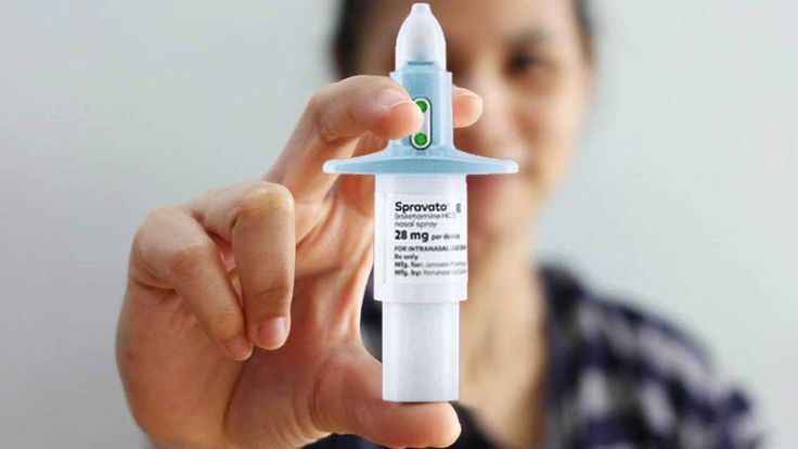 Person holding Spravato (esketamine) nasal spray used for treatment-resistant depression, highlighting prescription drug access and insurance coverage challenges.
