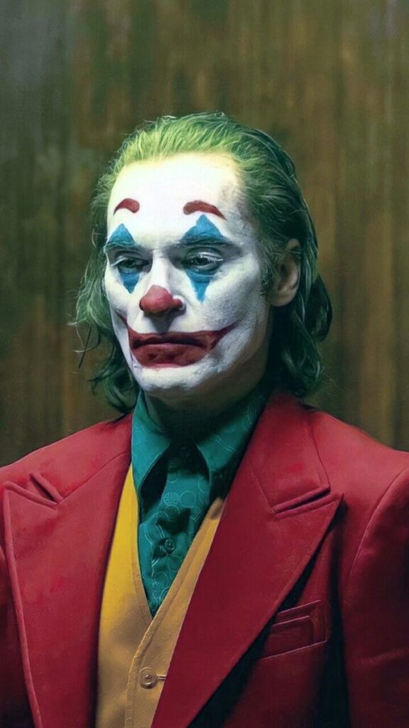 a man by diong joker makeup by wraring red fomal suit
