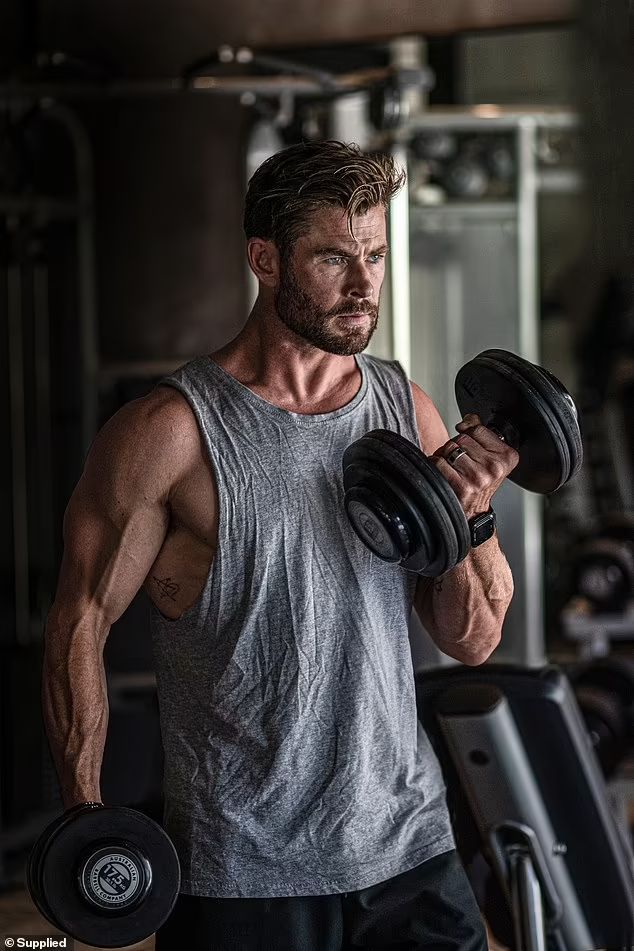 a man with holding dumble doing exersie
